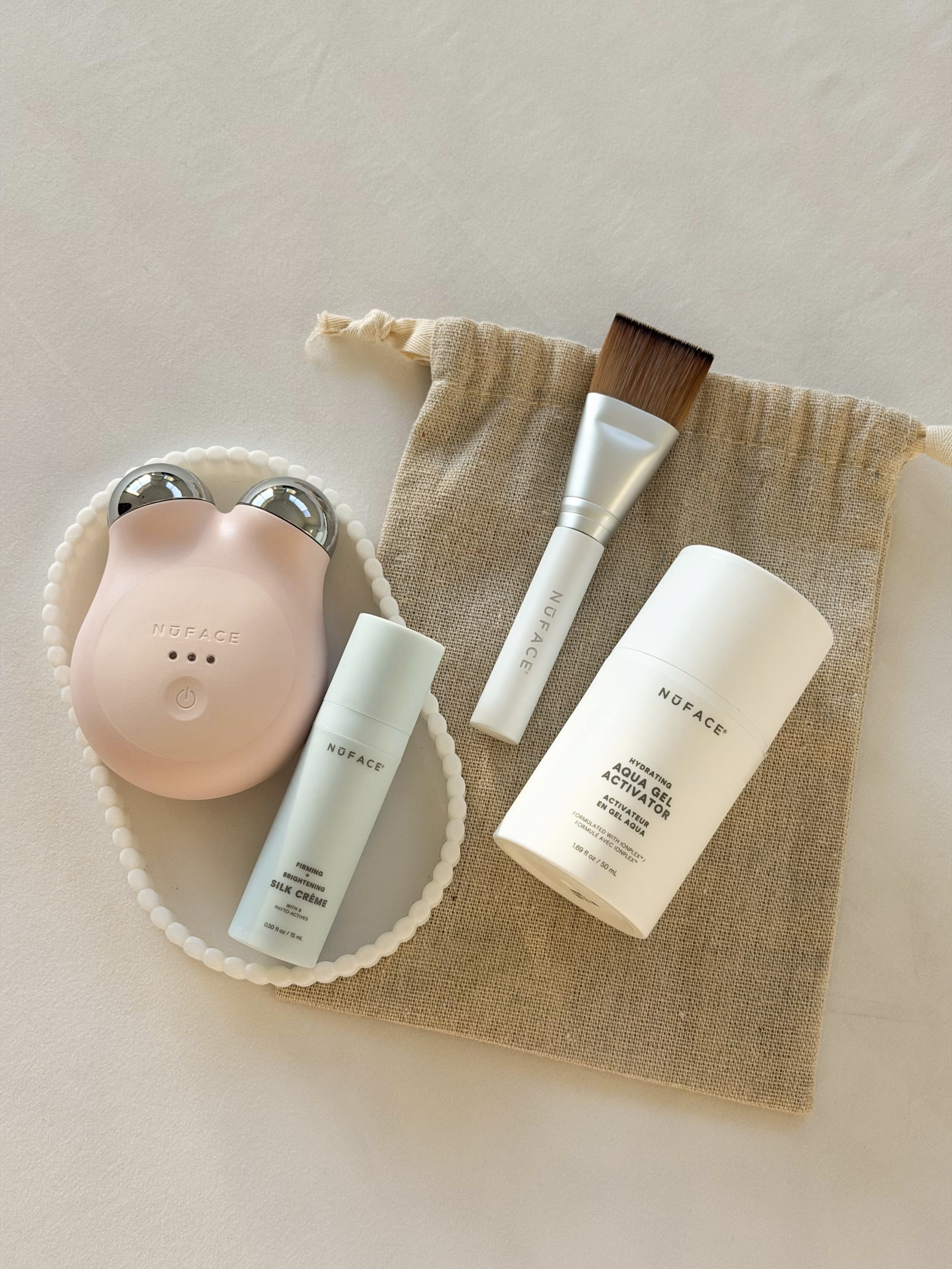 NuFACE skincare device and products flat lay